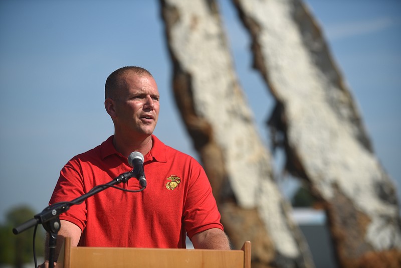 Marine Capt. Chris Cotton speaks as a crane raises a 65-foot-tall sculpture Tuesday, September 1, 2015, at the Sculpture Fields at Montague Park as a tribute to honor the five military members who were slain in July. Artist Peter Lundberg created the sculpture, named Anchors.