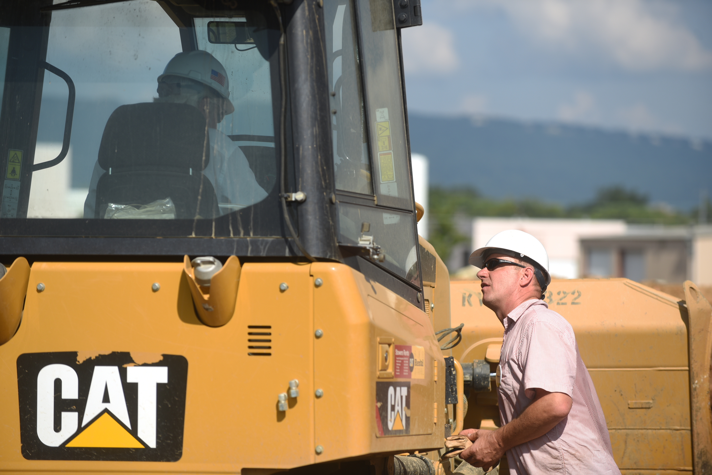 Artist Peter Lundberg, right, talks with John Henry as a crane raises a 65-foot-tall sculpture Tuesday, September 1, 2015, at the Sculpture Fields at Montague Park as a tribute to honor the five military members who were slain in July.