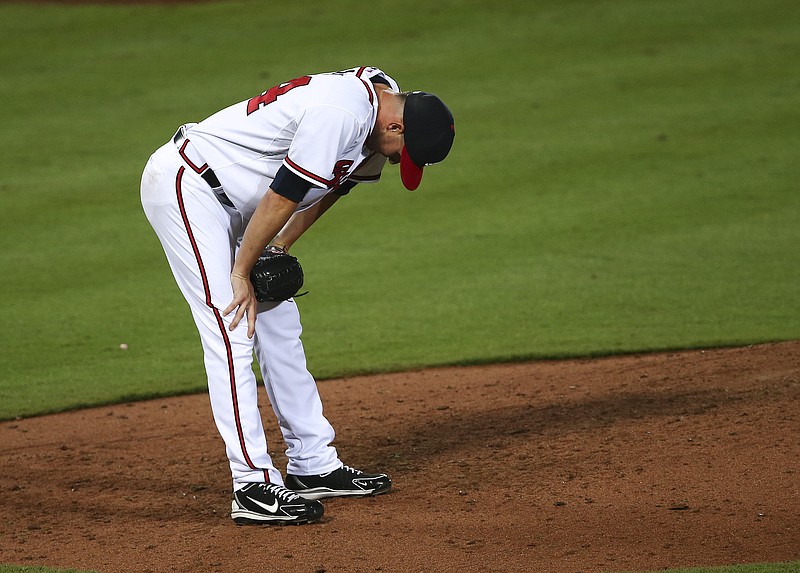 Relief pitcher Ryan Kelly shows the feeling of the flailing Atlanta Braves in general after giving up a three-run home run to Miami's Justin Bour in the seventh inning of Tuesday's 7-1 win for the visiting Marlins.