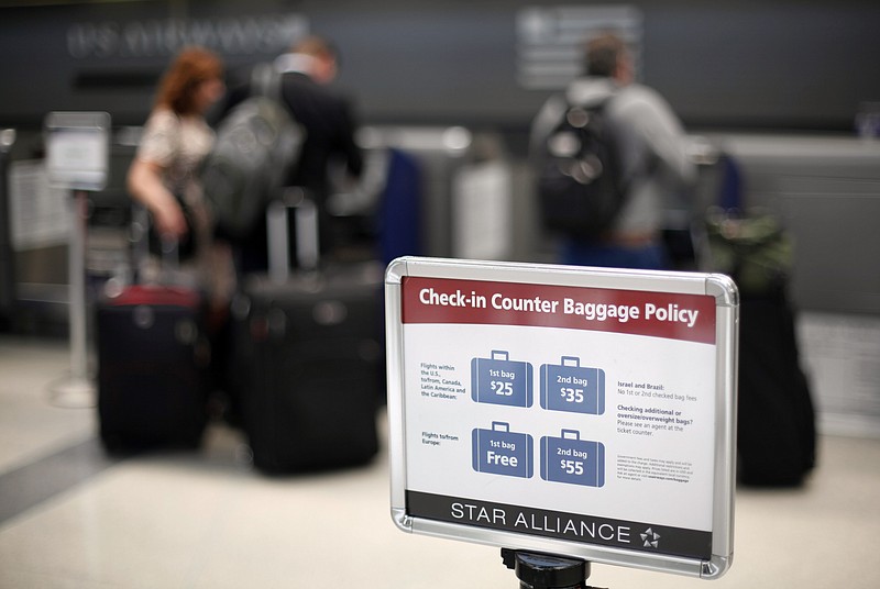 
              FILE - In this June 13, 2011 file photo, a fee sign is seen at Philadelphia International Airport in Philadelphia. Airlines should clearly disclose the cost of change and cancellation fees, as well as the size of the plane's seats, before a passenger buys a ticket, a federal panel said Tuesday. (AP Photo/Matt Rourke)
            