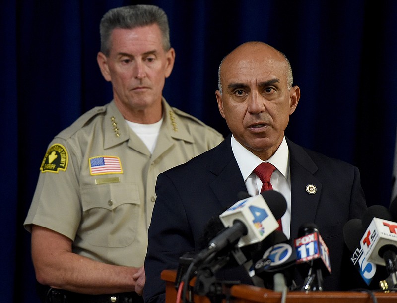 
              San Bernardino County District Attorney Mike Ramos, joined by Sheriff John McMahon, speaks during a press conference, Tuesday, Sept. 1, 2015, in San Bernardino, Calif., announcing that felony assault charges have been filed against San Bernardino County Sheriff's Deputies Nicholas Downey, Michael Phelps, and Charles Foster in the in the televised beating of Francis Pusok. A KNBC-TV helicopter news crew followed the chase as Frances Jared Pusok fled deputies on a stolen horse. The station then televised deputies repeatedly punching and kicking Pusok as he lay on the ground. Seven other deputies placed on administrative leave following the April pursuit in the inland desert were not charged. (John Valenzuela/The Sun via AP) MANDATORY CREDIT
            