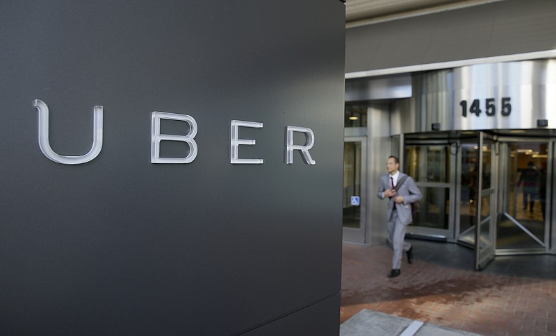 
              FILE - In this photo taken Tuesday, Dec. 16, 2014, a man leaves the headquarters of Uber in San Francisco. A federal judge granted class-action status Tuesday, Sept. 1, 2015, to a lawsuit in California against Uber over the payment of its drivers, upping the stakes for the ride-hailing company in the case. (AP Photo/Eric Risberg, File)
            