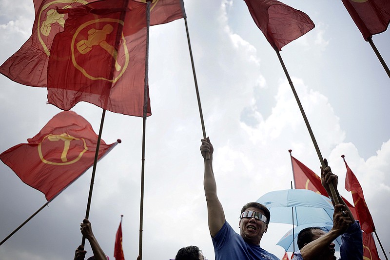 
              Singapore's opposition Workers' Party supporters cheer on their candidates at a nomination center, Tuesday, Sept. 1, 2015, in Singapore. Singapore will hold a general election on Sept. 11, in what is expected to be a tight contest for the ruling party that has dominated politics in the city-state for 50 years but is now facing growing disaffection among citizens. (AP Photo/Wong Maye-E)
            