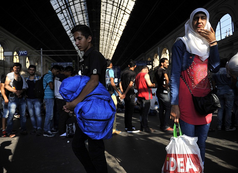 
              Migrants wait to board the train that will take them towards Munich, Germany at the Keleti Railway Station in Budapest, Hungary, Monday, Aug. 31, 2015. Migrants possessing valid documents and a train ticket are being allowed on international trains at the station.  (Tamas Kovacs/MTI via AP)
            