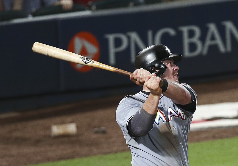 Miami Marlins first baseman Justin Bour (48) follows through on a three-run home run in the seventh inning of a baseball game against the Atlanta Braves on Tuesday, Sept. 1, 2015, in Atlanta.