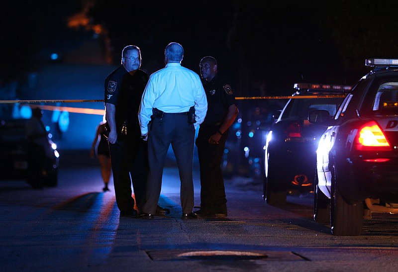 DeKalb County police officers work at the scene where an Atlanta-based officer was shot Monday evening, Aug. 31, 2015, five miles from Atlanta.