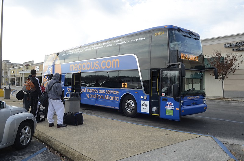 People wait to board the Megabus Wednesday at the Eastgate Town Center.