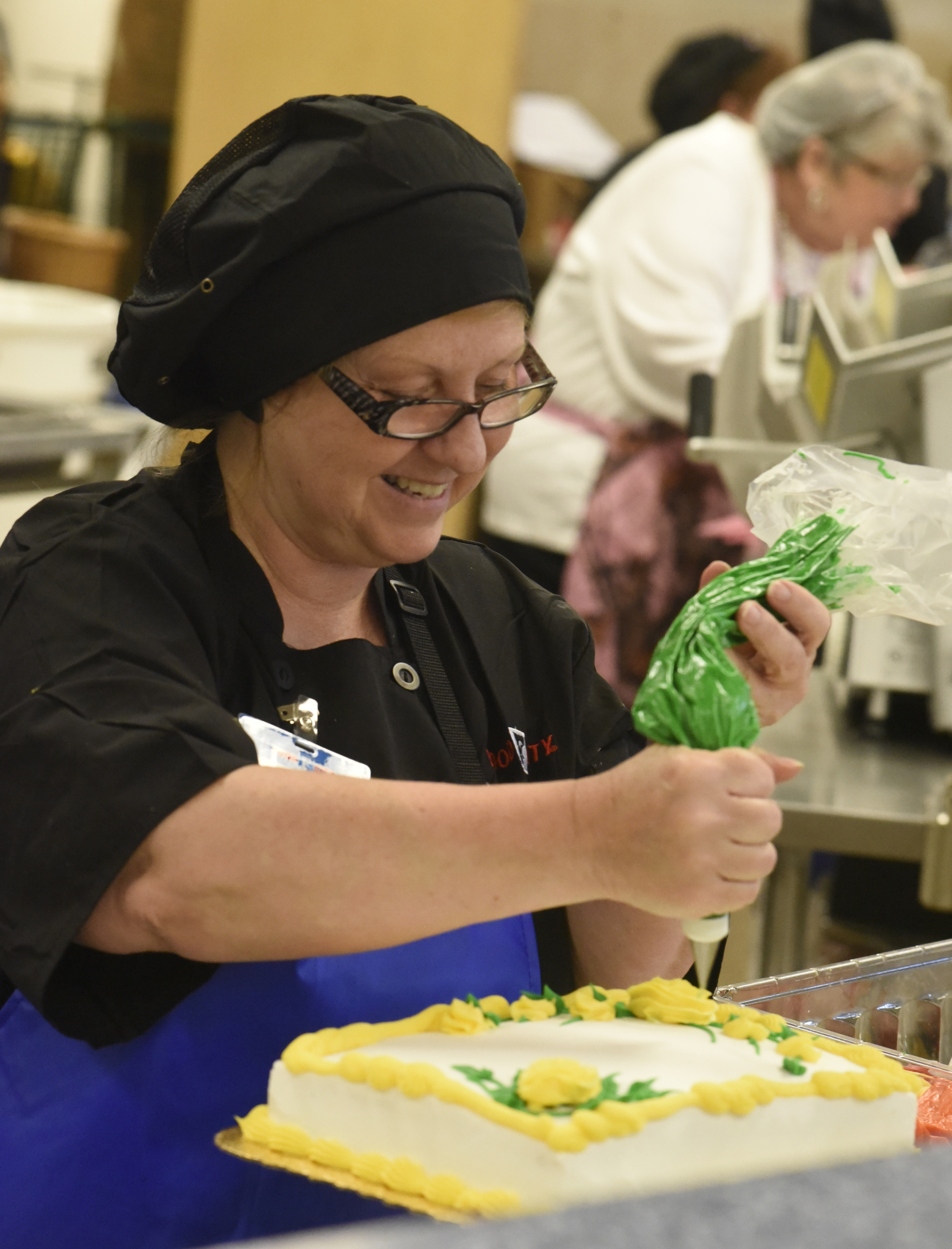Brenda Walters decorates a cake in the bakery on the first day of business for the new Food City grocery store Wednesday, Sept. 2, 2015, in Red Bank, Tenn. The store, formerly a Bi-Lo at the intersection of Morrison Springs Road and Dayton Boulevard, was reopened after a three-day turnaround.