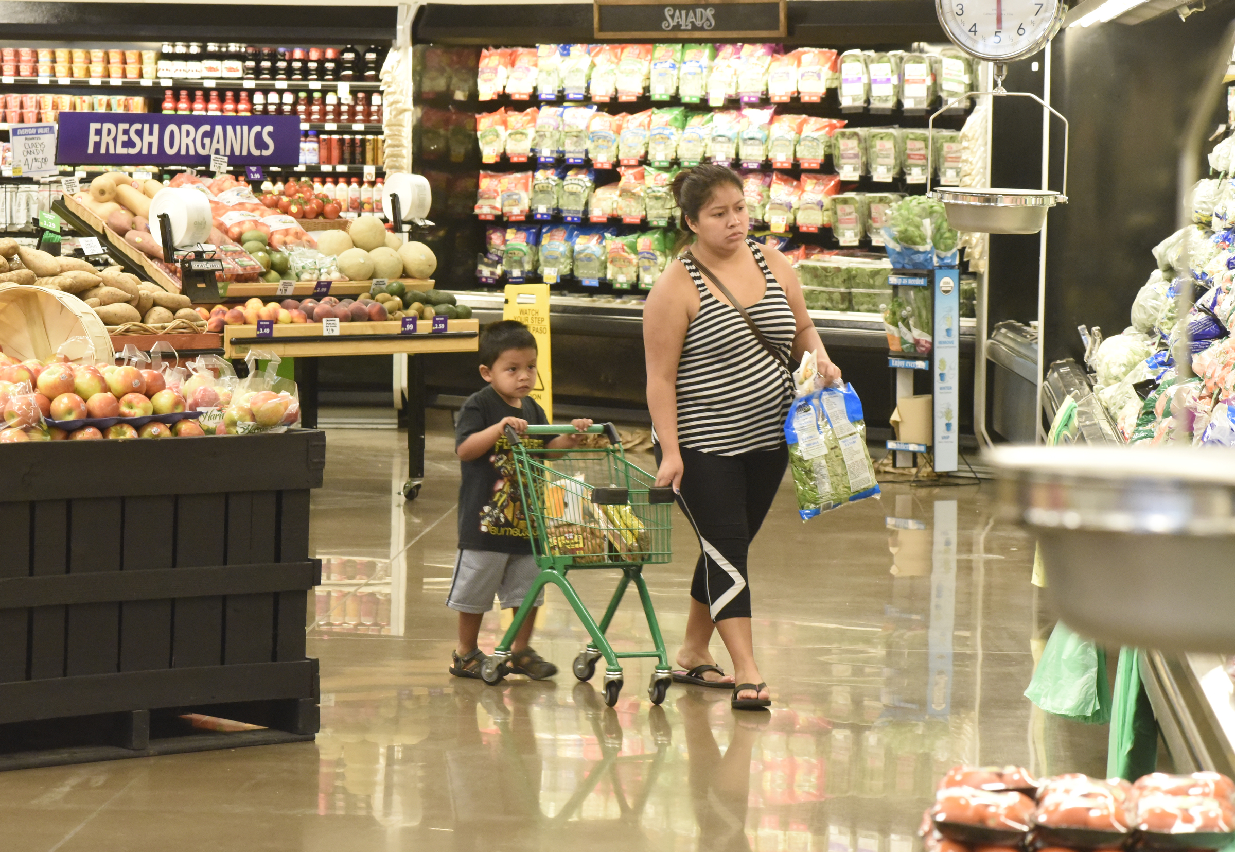 Aaron Andres, age 3, pushes a small grocery cart as he shops with his aunt Veronica Andres on the first day of business for the new Food City grocery store Wednesday, Sept. 2, 2015, in Red Bank, Tenn. The store, formerly a Bi-Lo at the intersection of Morrison Springs Road and Dayton Boulevard, was reopened after a three-day turnaround.