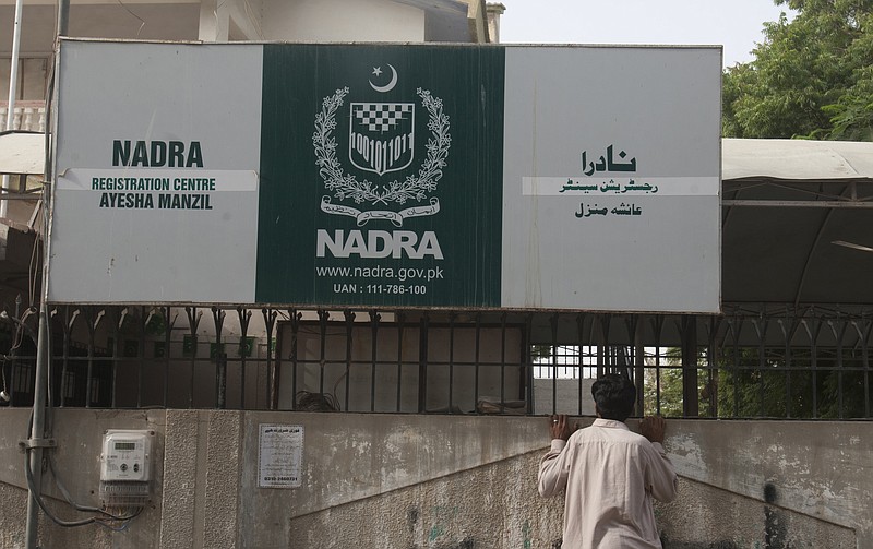 
              In this Tuesday, Sept. 1, 2015 photo, a man looks into the office of Pakistan's National Data and Registration Authority or NADRA which was closed by authorities in Karachi, Pakistan. Foreign Islamic militants have been able to secure Pakistani national identity cards in exchange for bribes as low as $100, giving them vastly greater freedom to operate, according to a report by Pakistan’s top intelligence agency obtained by The Associated Press. The main fault in the ID scandal seems to lies with corruption in Pakistan’s NADRA, the organization that issues national ID cards. (AP Photo/Shakil Adil)
            