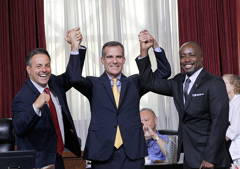 
              Councilman Joe Buscaino, left, with Los Angeles Mayor Eric Garcetti, center, and Councilman Marqueece Harris-Dawson celebrate after a city council vote in Los Angeles on Tuesday, Sept. 1, 2015. The Los Angeles City Council cleared the way Tuesday for Garcetti to strike agreements for a 2024 Olympics bid, putting the city on the verge of becoming the U.S. contender after Boston's awkward collapse. (AP Photo/Nick Ut)
            
