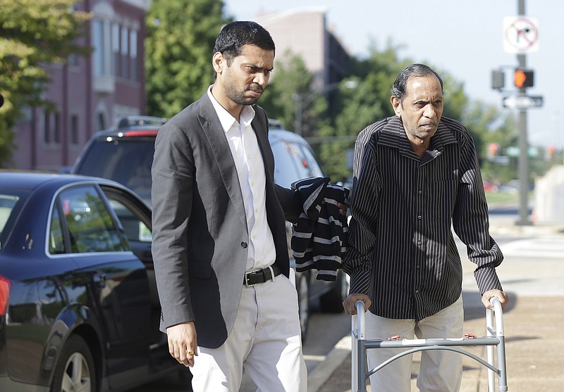 Chirag Patel helps his father, Sureshbhai Patel as they arrive outside the federal courthouse before start of a trial against Madison, Ala., police officer Eric Sloan Parker, Tuesday, Sept. 1, 2015, in Huntsville, Ala.
