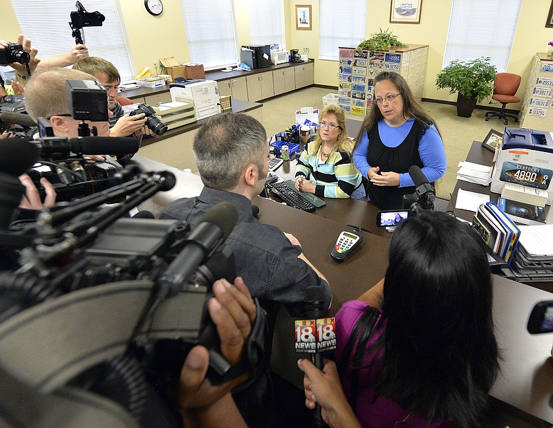 Rowan County Clerk Kim Davis, right, talks with David Moore following her office's refusal to issue marriage licenses at the Rowan County Courthouse in Morehead, Ky., Tuesday, Sept. 1, 2015. Although her appeal to the U.S. Supreme Court was denied, Davis still refuses to issue marriage licenses. 