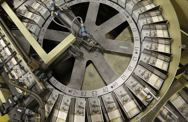 
              FILE - In this Sept. 24, 2013 file photo, freshly cut stacks of $100 bills make their way down the line at the Bureau of Engraving and Printing Western Currency Facility in Fort Worth, Texas. U.S. banks' earnings jumped 7.3 percent in the April-June period from a year earlier, the Federal Deposit Insurance Corp. reported Wednesday, Sept. 2, 2015, as revenues increased and the volume of soured loans banks had to write off fell to the lowest level since before the financial crisis. (AP Photo/LM Otero, File)
            