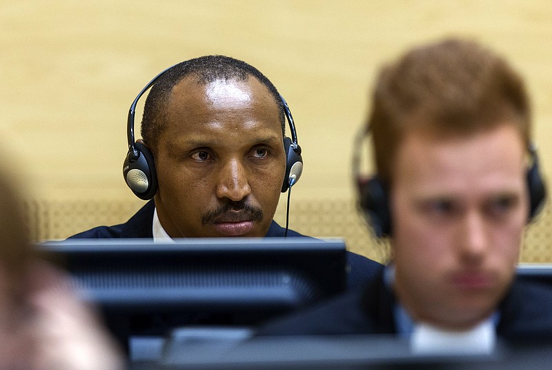 
              Bosco Ntaganda, a Congo militia leader known as The Terminator, waits for the start of his trial at the International Criminal Court on charges including murder, rape and sexual slavery allegedly committed in the eastern Ituri region of Congo from 2002-2003, in The Hague, Netherlands, Wednesday, Sept. 2, 2015. (Michael Kooren/Pool Photo via AP)
            