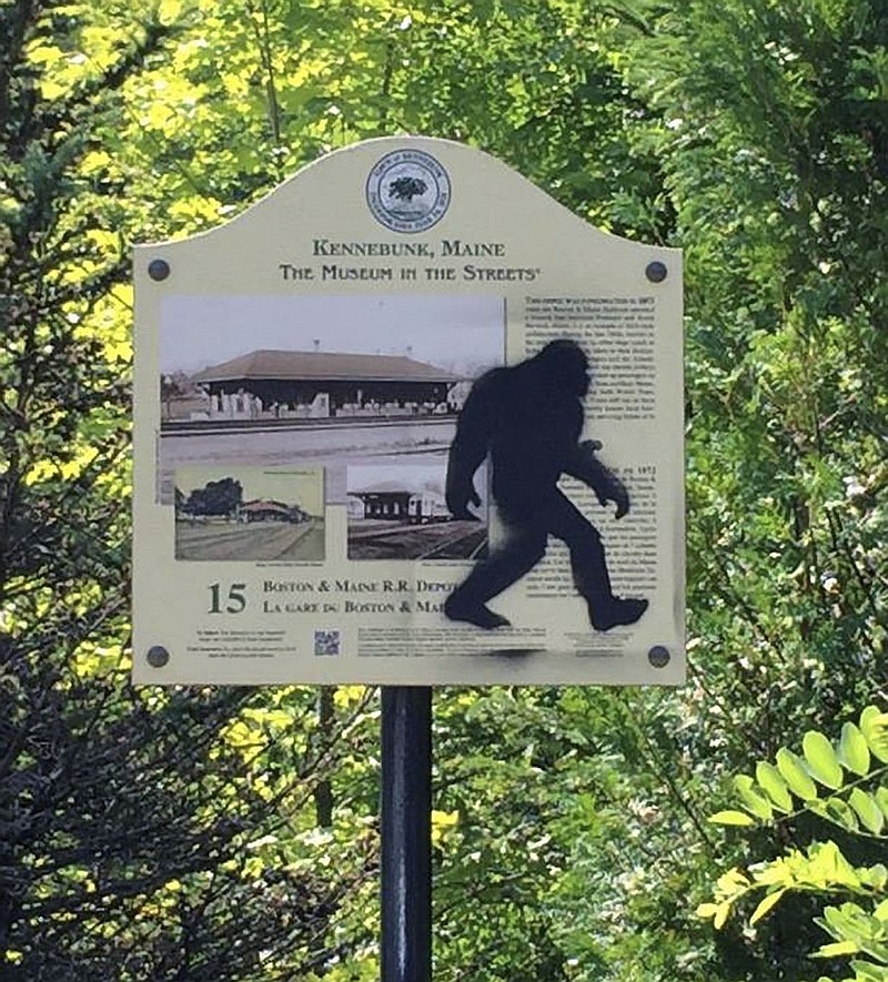 This Aug. 19, 2015 photo provided by the Kennebunk Police Department shows an graffiti on a sign in Kennebunk, Maine. Authorities have nabbed a man who's accused of spray-painting images of Sasquatch on public property in Kennebunk, Maine. Police in the picturesque coastal town didn't find the graffiti featuring Bigfoot all that amusing and charged 36-year-old Freeman Hatch with criminal mischief and possession of drugs. 