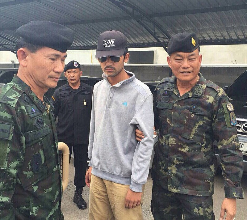 In this image provided by the National Council for Peace and Order (NCPO) Thai authorities arrest a man they believe is part of a group responsible for a deadly bombing at a shrine in central Bangkok on Aug. 17, 2015.