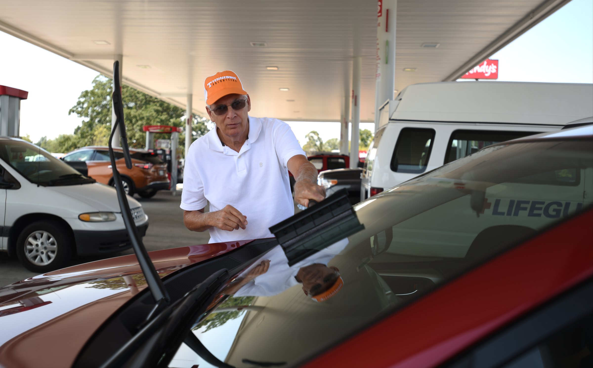 Dale Pendley washes his windows while getting gas on his way home to McNairy County on Thursday, September 3, 2015 at Speedway on Bonny Oaks Drive.