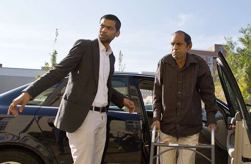 
              Chirag Patel helps his father, Sureshbhai Patel, out of the car as they arrive outside the federal courthouse before start of a trial against Madison, Ala., police Officer Eric Sloan Parker, Tuesday, Sept. 1, 2015, in Huntsville, Ala. Sureshbhai Patel, who was visiting relatives from his native India in February, was walking in his son's neighborhood when police responding to a call about a suspicious person stopped to question him. A police video captured an officer slamming the man to the ground, partially paralyzing him. (AP Photo/Brynn Anderson)
            