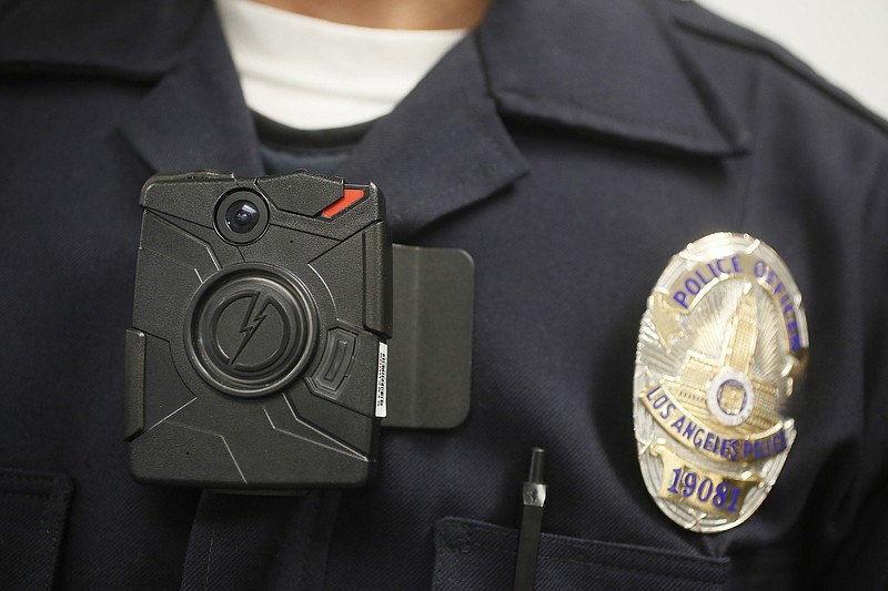 
              FILE- In this Jan. 15, 2014 file photo a Los Angeles Police officer wears an on-body camera during a demonstration in Los Angeles. The Los Angeles Police Department’s effort to equip officers with body cameras has run up against an unlikely obstacle, the ACLU of Southern California. The civil rights organization sent a letter Thursday, Sept. 3, to the U.S. Justice Department urging it to deny funding for the cameras until the LAPD revamps its camera policy, which the ACLU said is seriously flawed. (AP Photo/Damian Dovarganes, File)
            