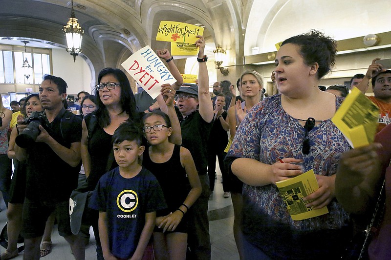 Protesters who want to control the future of Dyett High School protest and block elevators in the lobby of City Hall, Thursday, Sept. 3, 2015 in Chicago. (Nancy Stone/Chicago Tribune via AP) MANDATORY CREDIT CHICAGO TRIBUNE