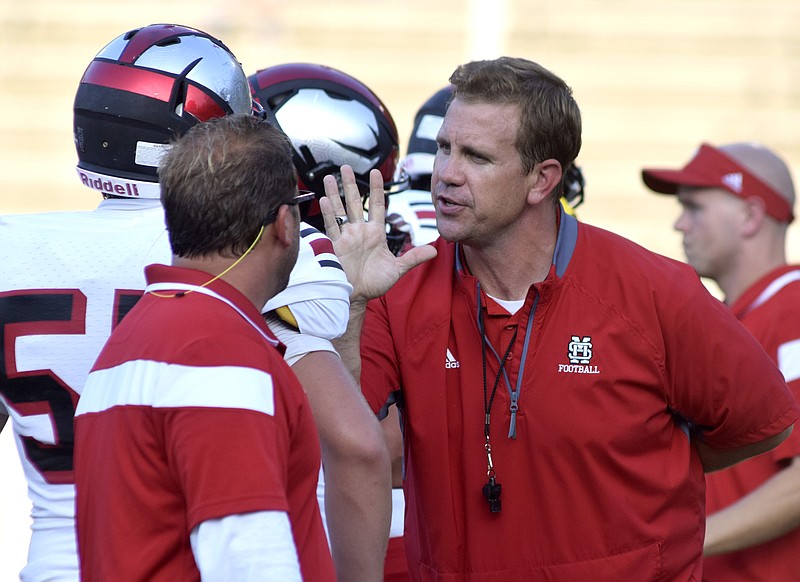 Signal Mountain head coach Ty Wise directs a player during warm ups. The East Ridge Pioneers hosted the Signal Mountain Eagles at Baylor School in TSSAA football action on Friday September 4, 2015.