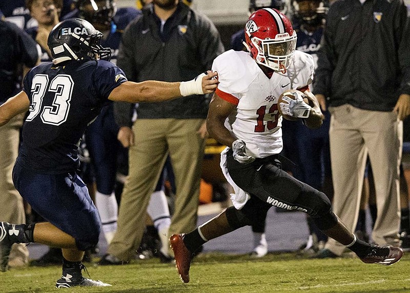 Woodward Academy running back Elijah Holyfield, right, the son of five-time boxing champion Evander Holyfield, heads toward the end zone with a touchdown catch during a 2014 game against Eagle's Landing Christian Academy last season. Holyfield, who had a seven-touchdown game last season as a junior, has committed to the University of Georgia. He is rated as a top-five running back nationally by two recruiting sites.