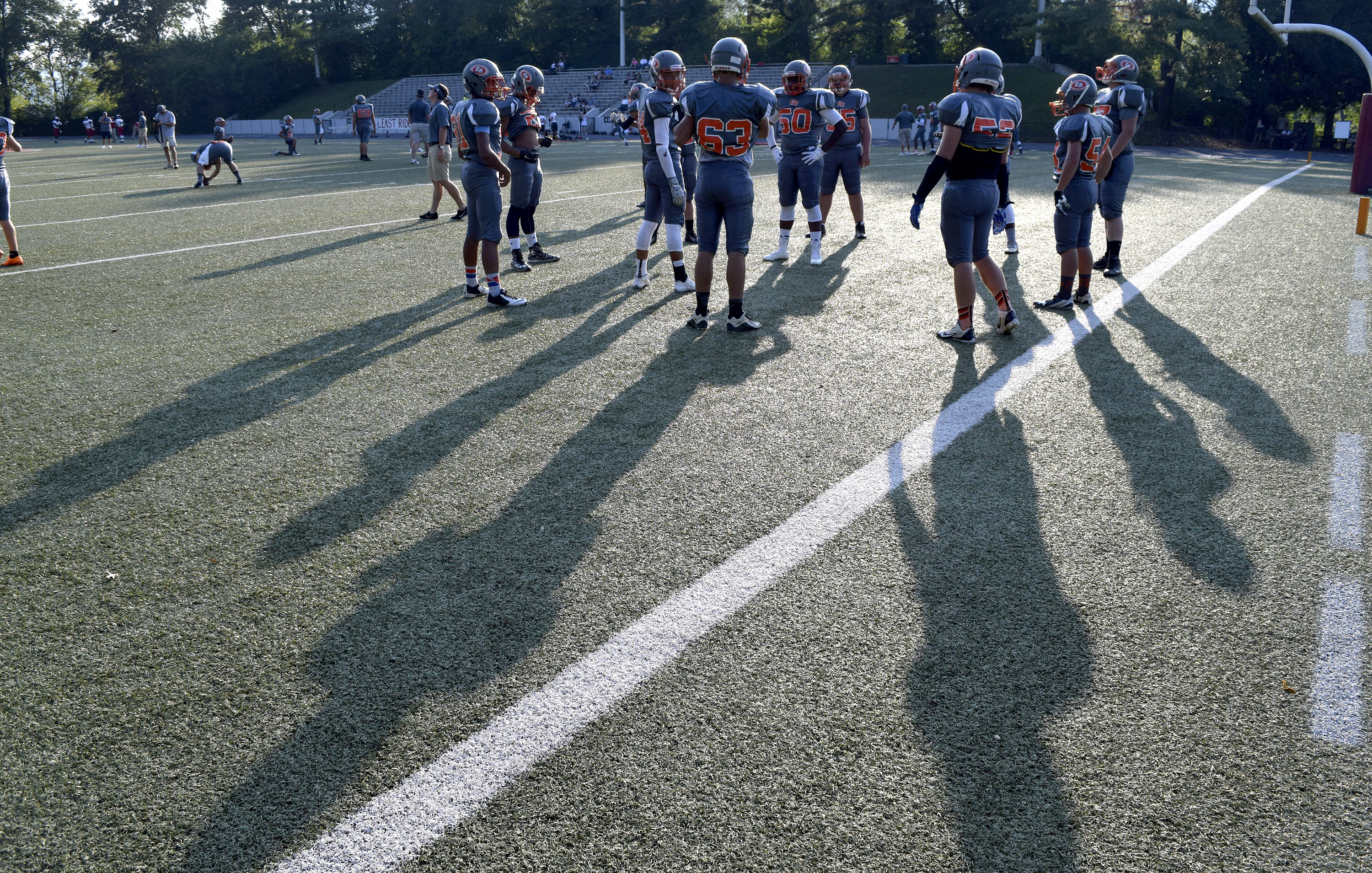 East Ridge players cast long shadows as they warm up.  The East Ridge Pioneers hosted the Signal Mountain Eagles at Baylor School in TSSAA football action on Friday September 4, 2015.