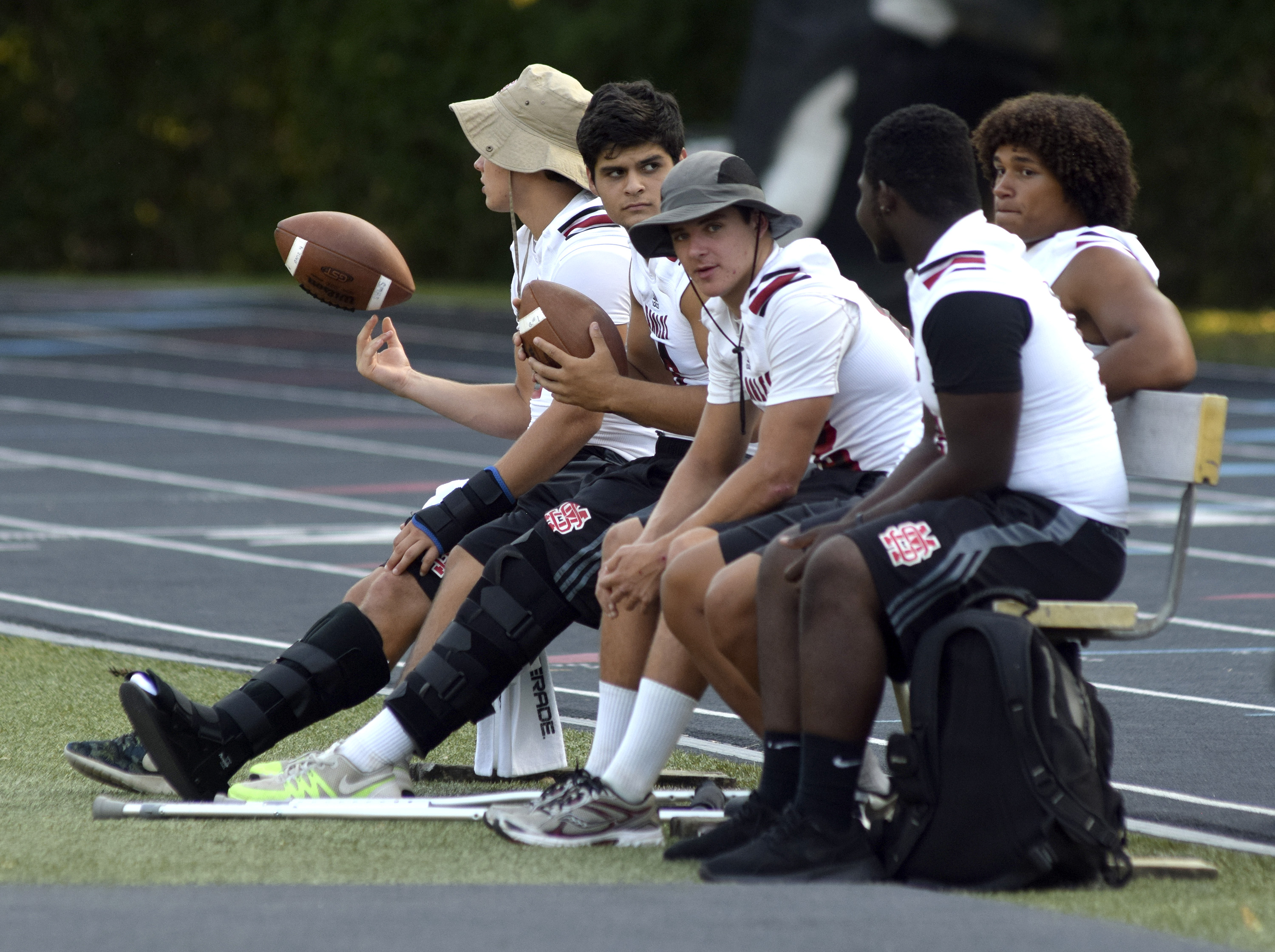 Five injured Signal Mountain Eagles wait for the game to start.  The East Ridge Pioneers hosted the Signal Mountain Eagles at Baylor School in TSSAA football action on Friday September 4, 2015.
