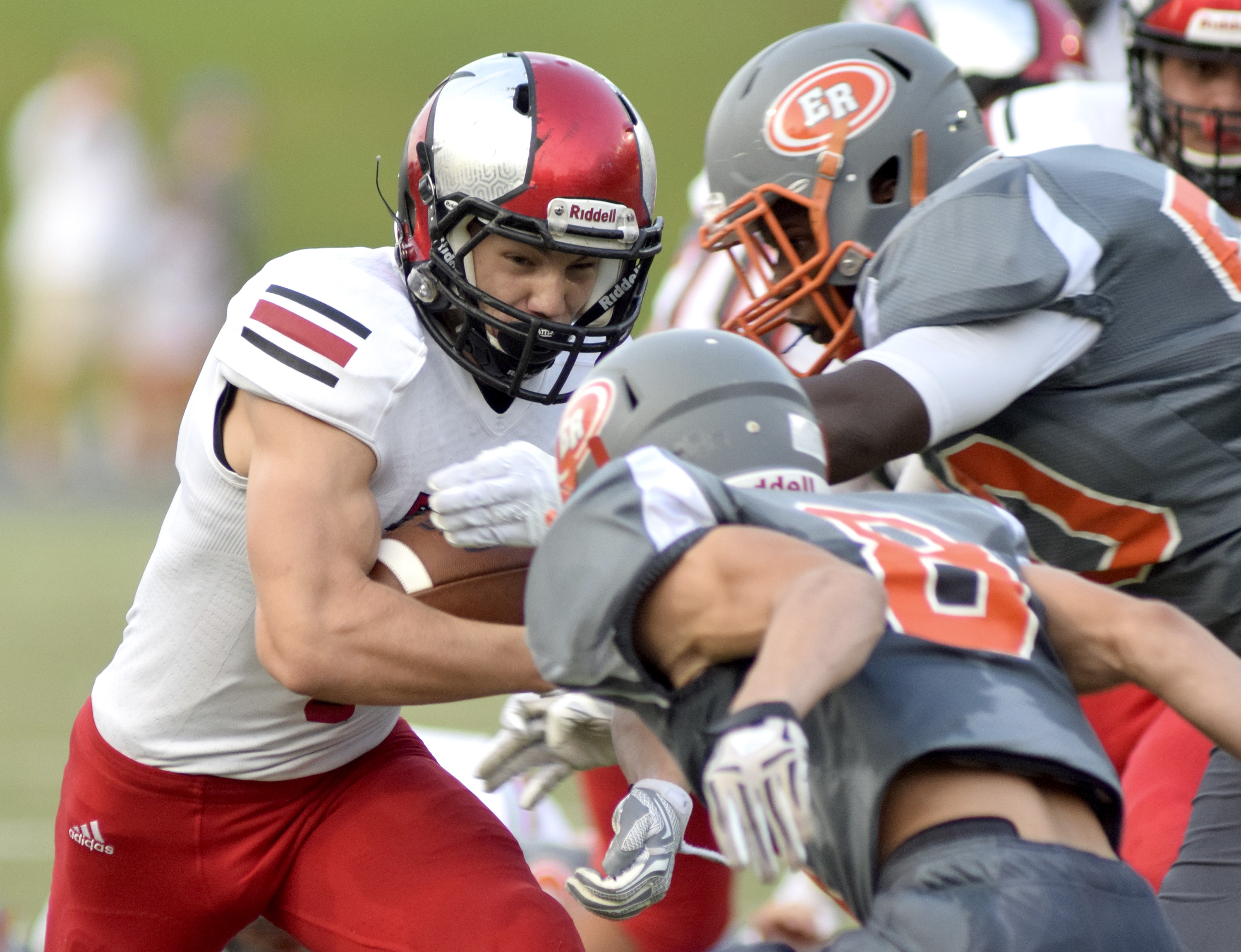 Signal Mountain running back Charlie Gauthier (1) is met headon by East Ridge's Deondre Chambliss (50) and Josh Williams (8).  The East Ridge Pioneers hosted the Signal Mountain Eagles at Baylor School in TSSAA football action on Friday September 4, 2015.