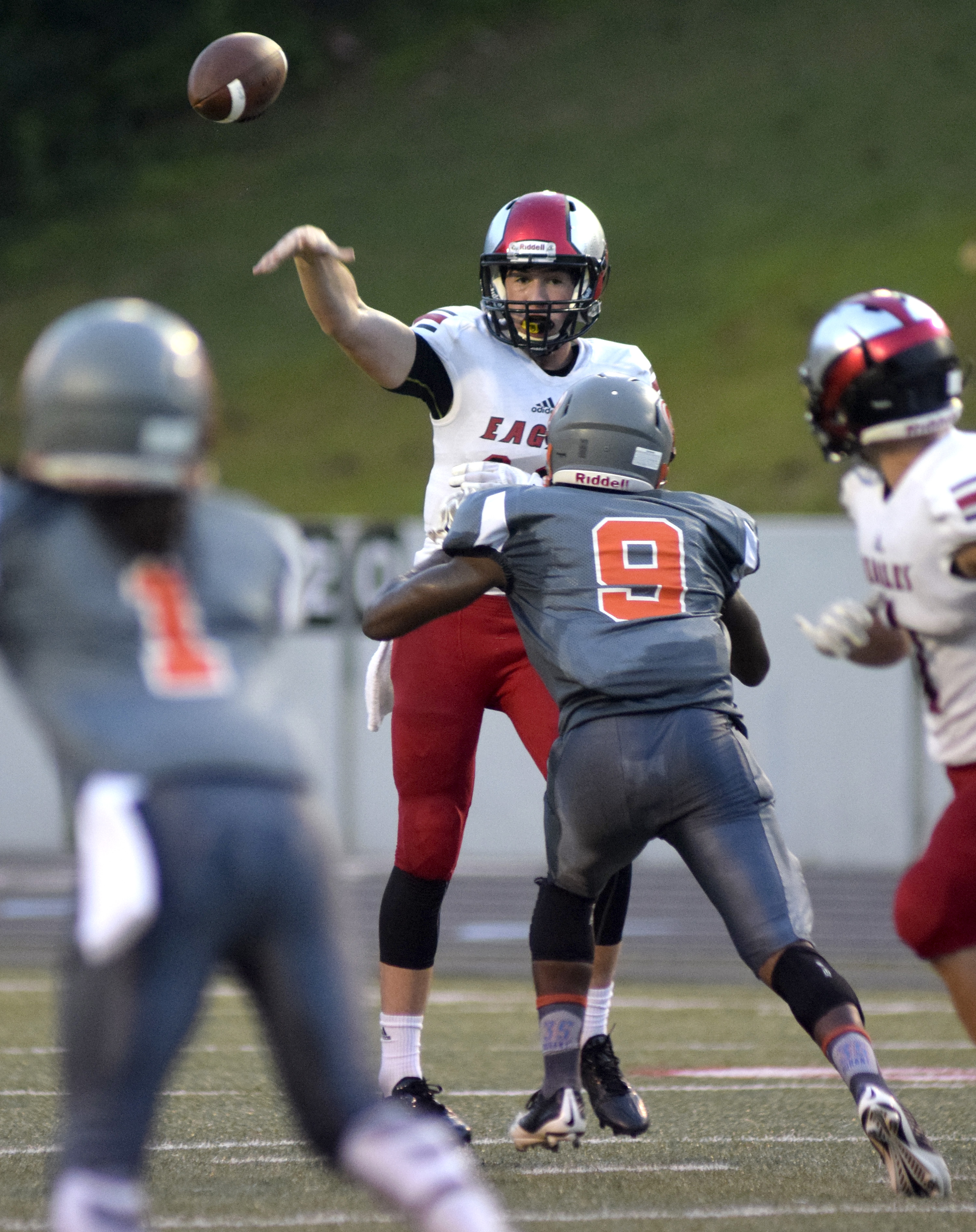 Signal Mountain quarterback Tom Vatter passes over East Ridge's Quasey Vinton (9).  The East Ridge Pioneers hosted the Signal Mountain Eagles at Baylor School in TSSAA football action on Friday September 4, 2015.