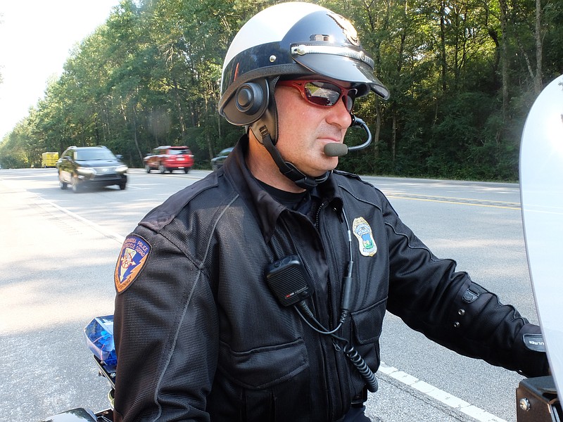 Chattanooga Police Investigator Tom Seiter, 46, works his traffic division duty on a motorcycle during the Friday afternoon rush in the 4000 block of Amnicola Highway. "From this seat, I'm sitting high enough to see the position of seat belts," Seiter said.