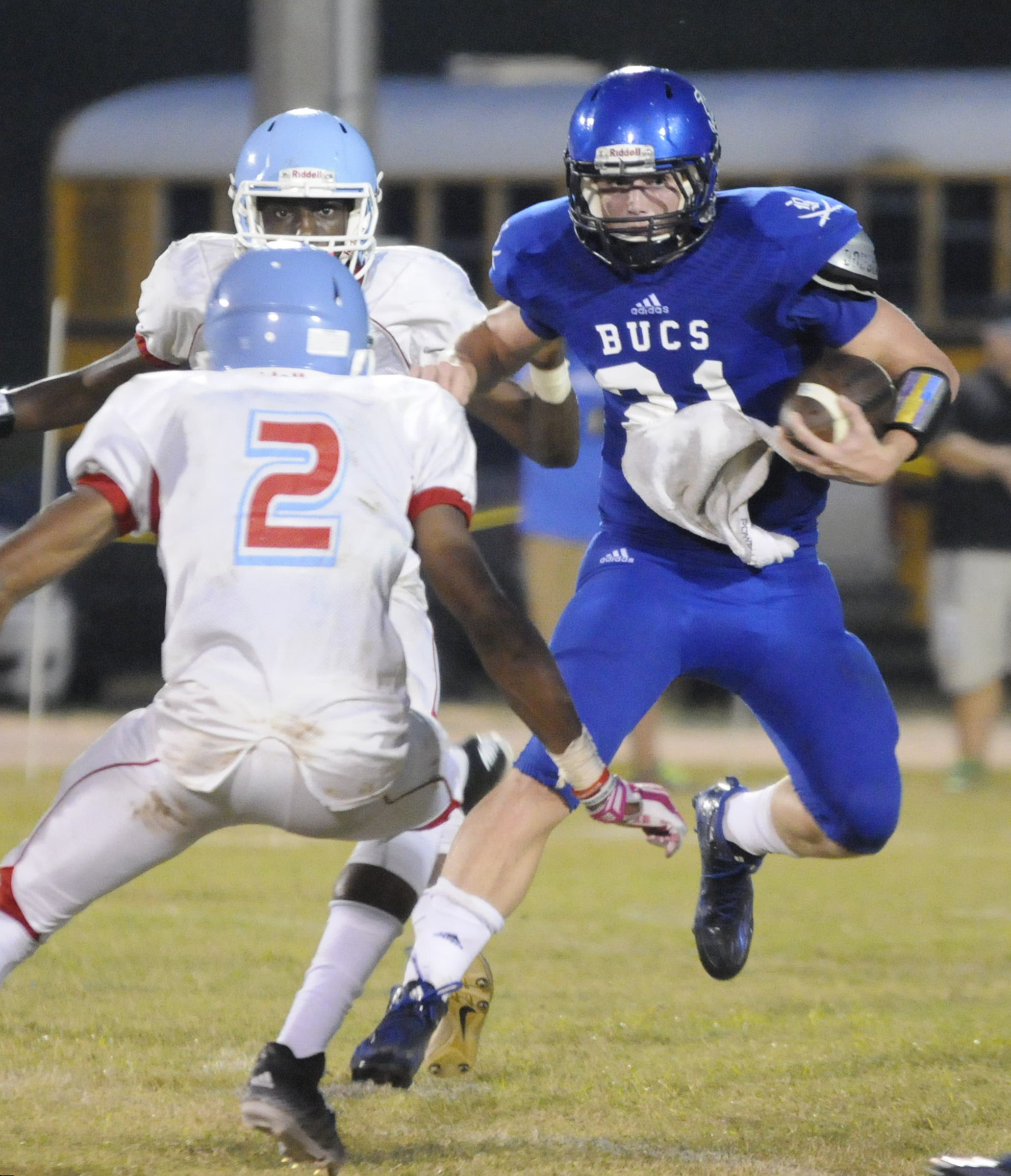 Brainerd's Jacorie Montgomerey (2) sets his sites on Boyd-Buchanan's Cooper Hodge (21) during a punt return Friday in first half action. Brainerd's Malik Beavers, top left, chases.