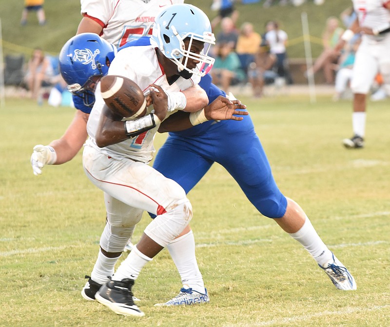 Boyd-Buchanan's Jack Keebler causes a fumble when he hits Brainerd's Malik Beavers (1) in first half action.