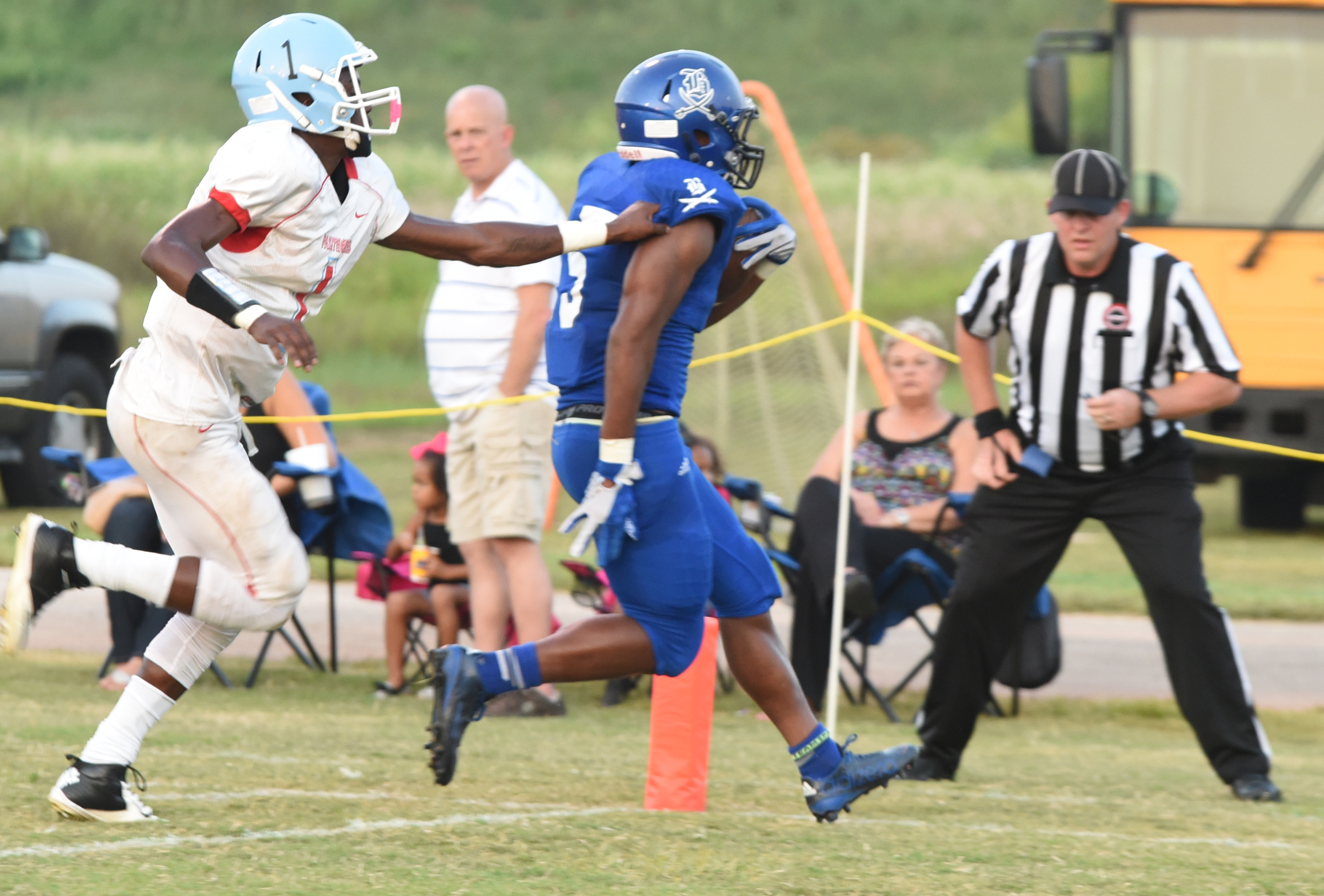 Boyd-Buchanan's E.J. Matthews (5) crosses the goal line for the first touchdown of the night with Brainerd's Malik Beavers (1) right behind.