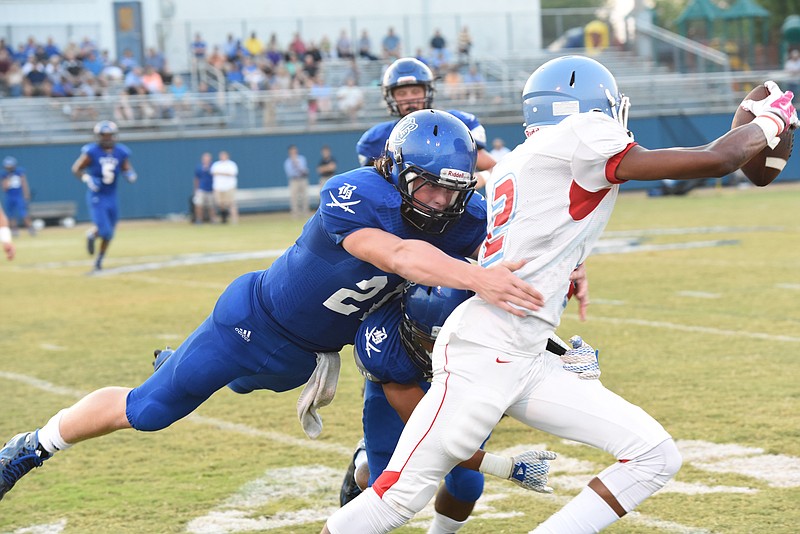 Brainerd Jacorie Montgomerey (2) stretches to get yardage as Boyd-Buchanan's Cooper Hodge (21) makes a hit on him early in first half action at Boyd in this file photo.