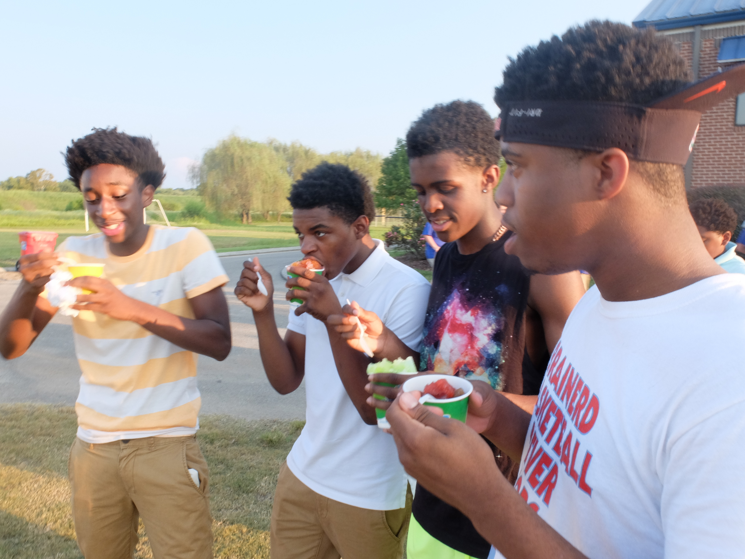 Brainerd Panther fans Demba Sow, left, Jailen Moore, Vesta Melvin and Isaiah Shropshire enjoy some fruit-flavored Kona Ice before Friday's game at Boyd-Buchanan.