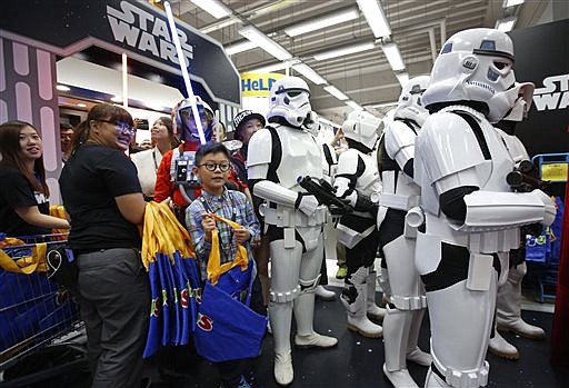 Star Wars fans shop at a toy store at midnight in Hong Kong, Friday, Sept. 4, 2015 as part of the global event called "Force Friday" to release new Star Wars toys and other merchandise of the new movie "Star Wars: The Force Awakens".