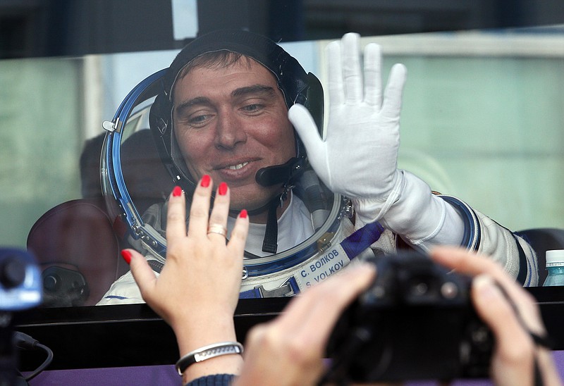 
              Russian cosmonaut Sergei Volkov, member of the main crew of the expedition to the International Space Station (ISS), waves to his relatives from a bus prior the launch of Soyuz-FG rocket at the Russian leased Baikonur cosmodrome, Kazakhstan, Wednesday, Sept. 2, 2015.  (AP Photo/Dmitry Lovetsky, Pool)
            