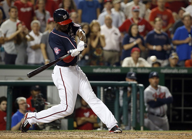 Washington Nationals' Michael Taylor hits a three-run homer to win the game during the 10th inning of a baseball game against the Atlanta Braves at Nationals Park, Friday, Sept. 4, 2015, in Washington. The Nationals won 5-2. 