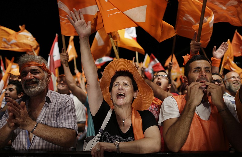 
              Supporters of Christian leader Michel Aoun hold Free Patriotic Movement and Lebanese flags, during a protest in downtown Beirut, Lebanon, Friday, Sept. 4, 2015. Michel Aoun, leader of the Free Patriotic Movement, had urged a heavy turnout at the demonstration, which is separate from recent anti-government protests over the country’s ongoing trash crisis.(AP Photo/Hassan Ammar)
            
