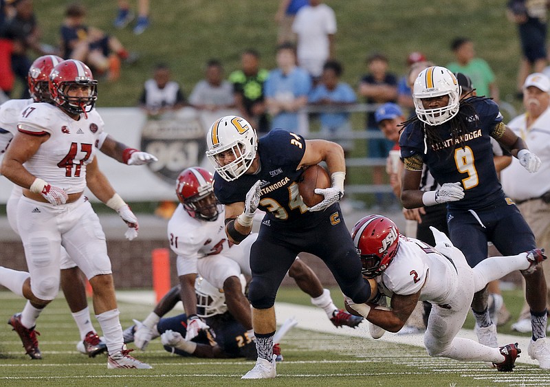 UTC running back Derrick Craine (34) is tackled by Jacksonville State cornerback Jermaine Hough during the Mocs' season-opener football game against Jacksonville State at Finley Stadium on Saturday, Sept. 5, 2015, in Chattanooga, Tenn.