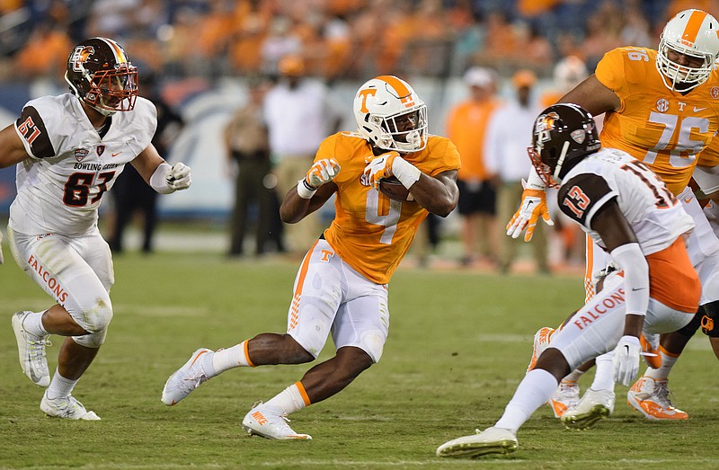 Tennessee's John Kelly (4) looks for running room between two Falcon defenders. The Tennessee Volunteers hosted the Bowling Green Falcons at Nissan Stadium in Nashville September 5, 2015.