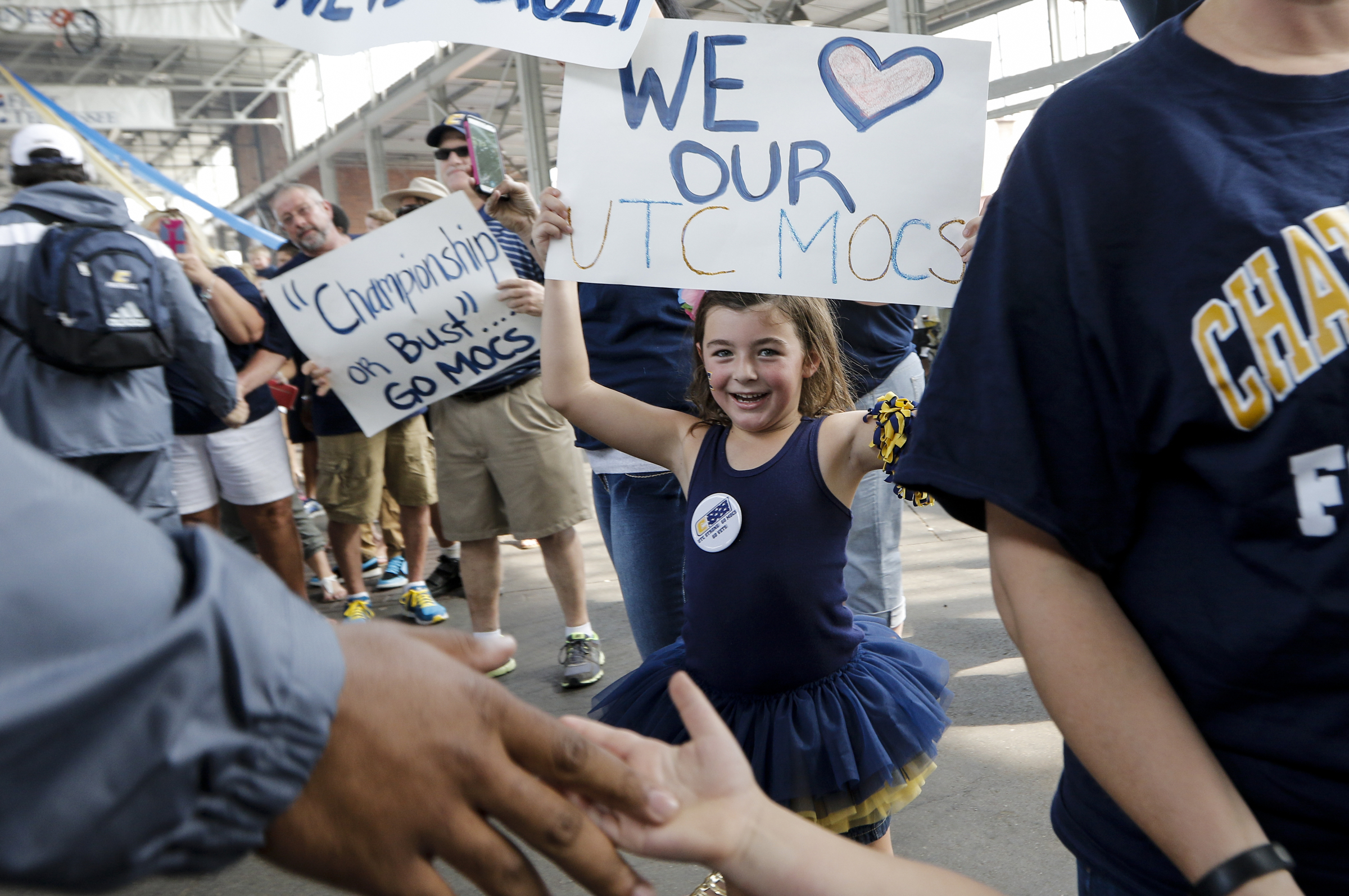 Addison Roche, whose uncle is UTC offensive lineman Corey Levin, cheers as the UTC football team enters First Tennessee Pavilion before the Mocs' season-opener football game against Jacksonville State at Finley Stadium on Saturday, Sept. 5, 2015, in Chattanooga, Tenn.