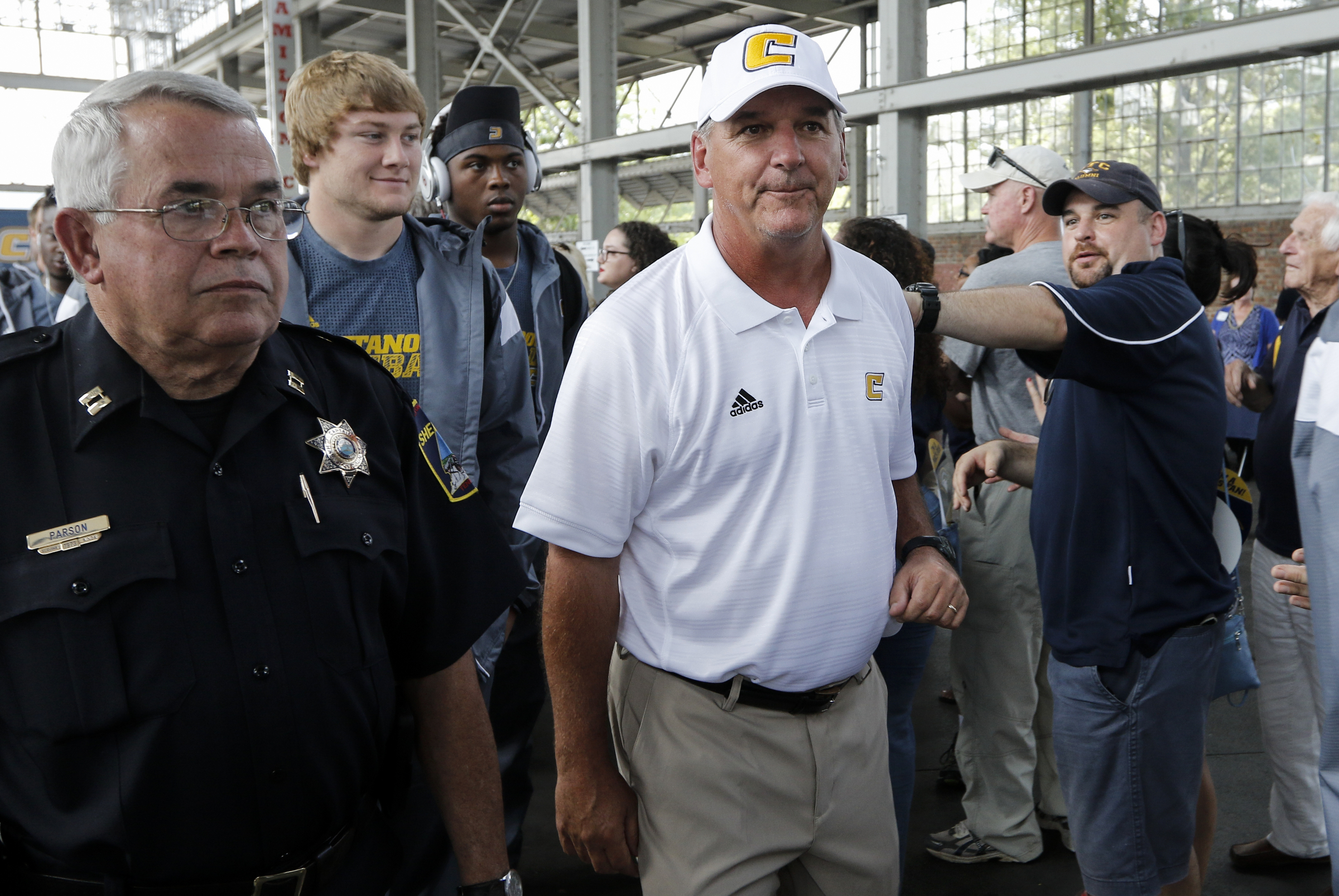 Head football coach Russ Huesman and the UTC football team enter the First Tennessee Pavilion before the Mocs' season-opener football game against Jacksonville State at Finley Stadium on Saturday, Sept. 5, 2015, in Chattanooga, Tenn.