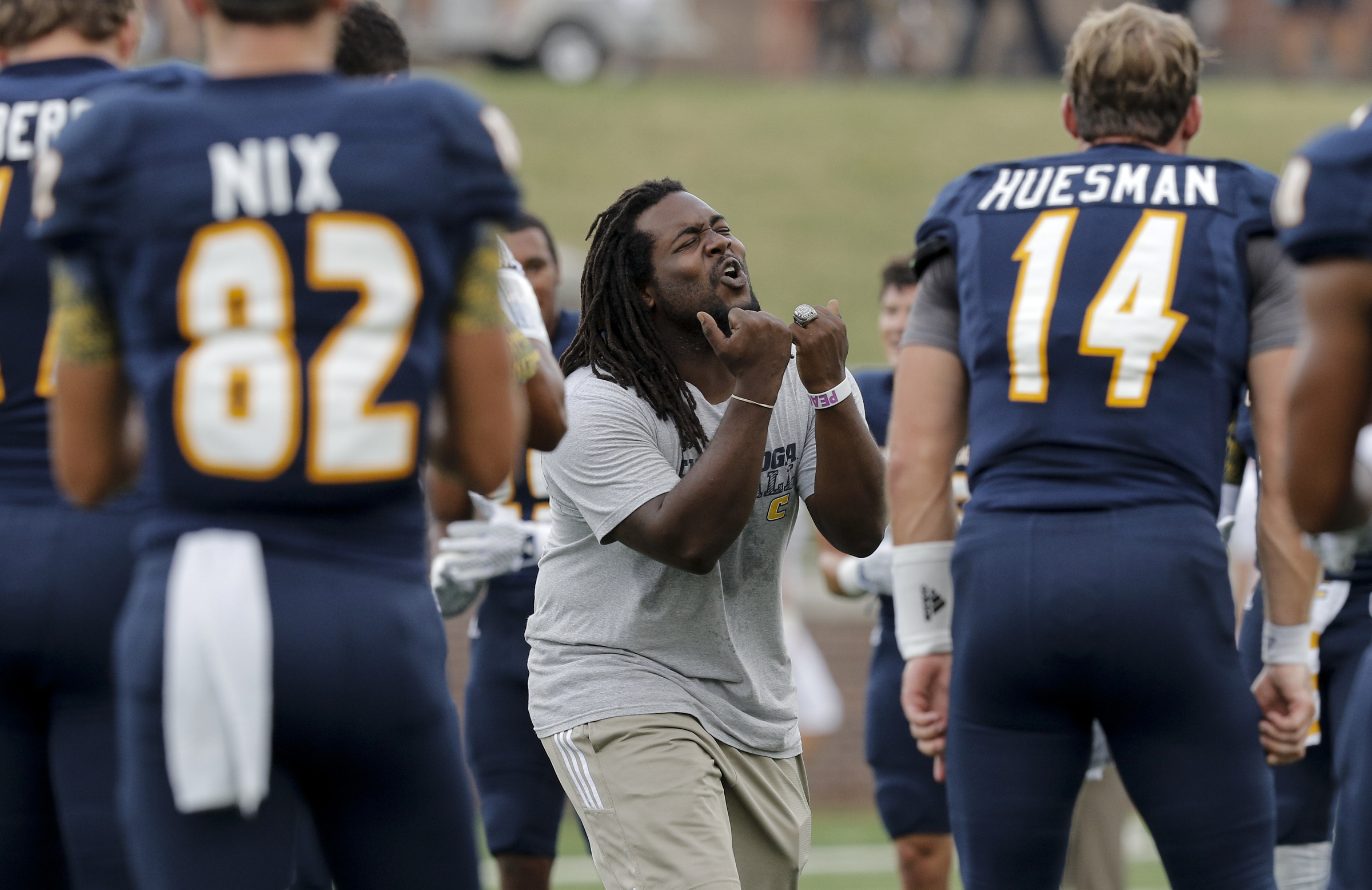 Former UTC player Taharin Tyson, who will graduate in December but was asked to return this game for his role in pumping the team up, shouts before the Mocs' season-opener football game against Jacksonville State at Finley Stadium on Saturday, Sept. 5, 2015, in Chattanooga, Tenn.