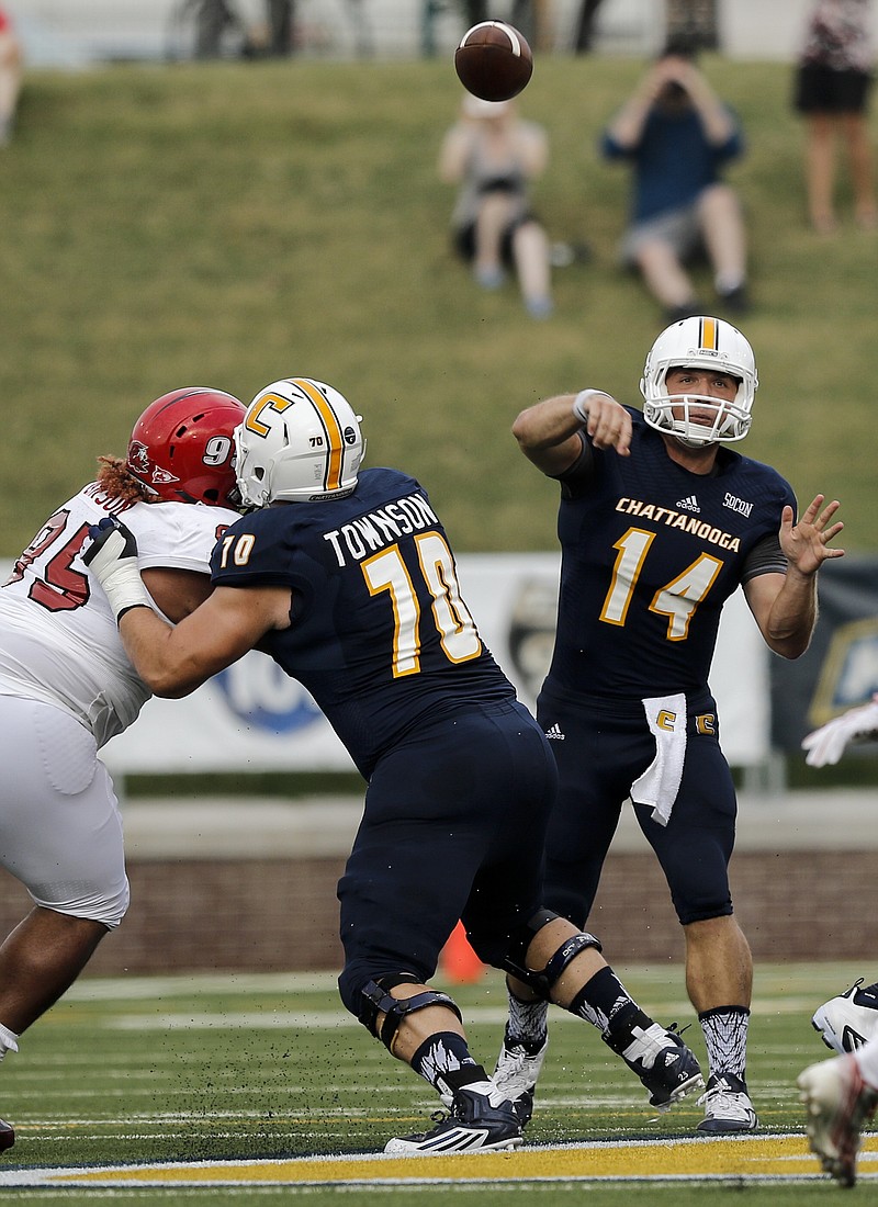 UTC quarterback Jacob Huesman passes under protection from offensive lineman Hunter Townson during the Mocs' season-opener football game against Jacksonville State at Finley Stadium on Saturday, Sept. 5, 2015, in Chattanooga, Tenn.