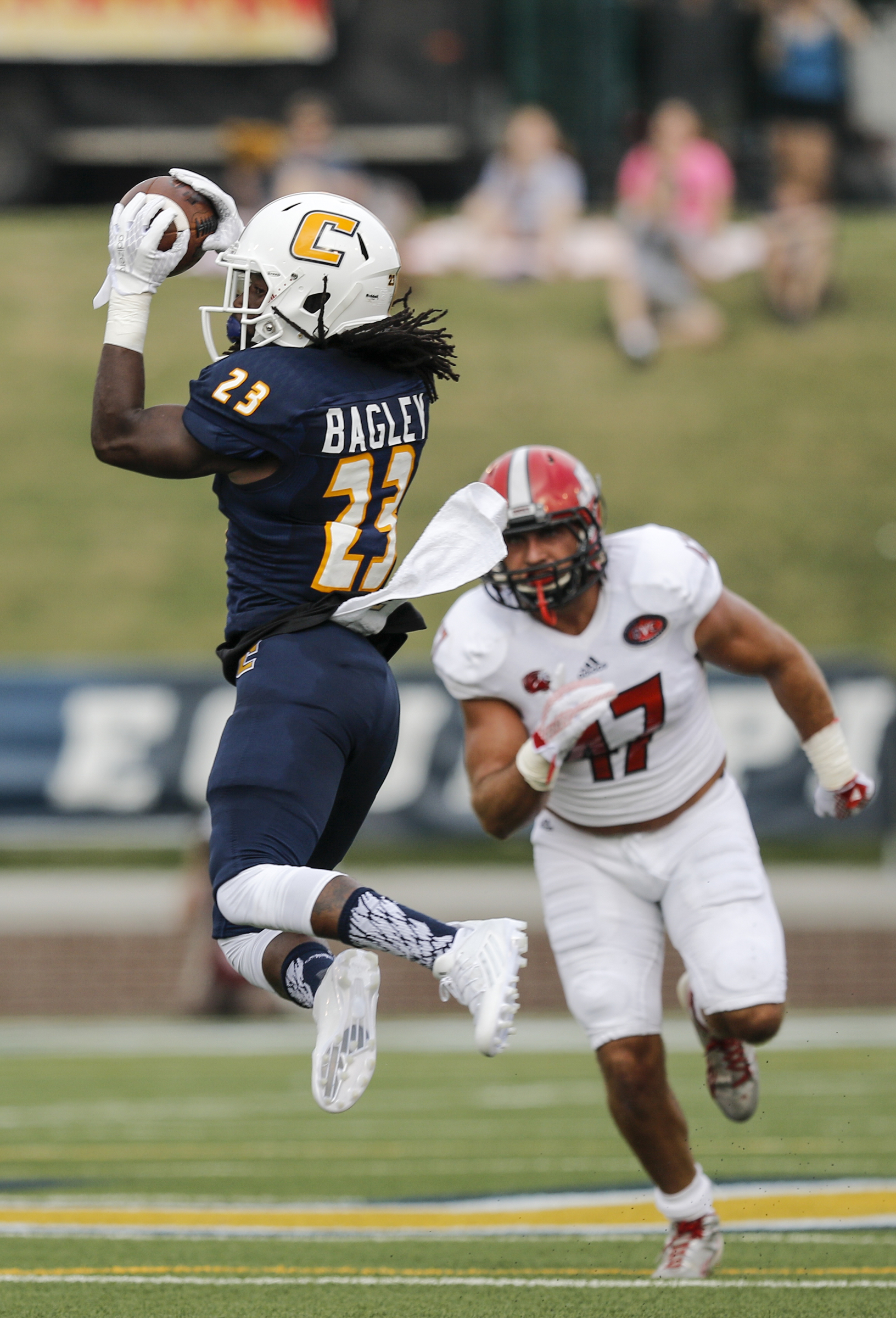 UTC running back Richardre Bagley catches a pass ahead of Jacksonville State linebacker Tre' Garland during the Mocs' season-opener football game against Jacksonville State at Finley Stadium on Saturday, Sept. 5, 2015, in Chattanooga, Tenn.