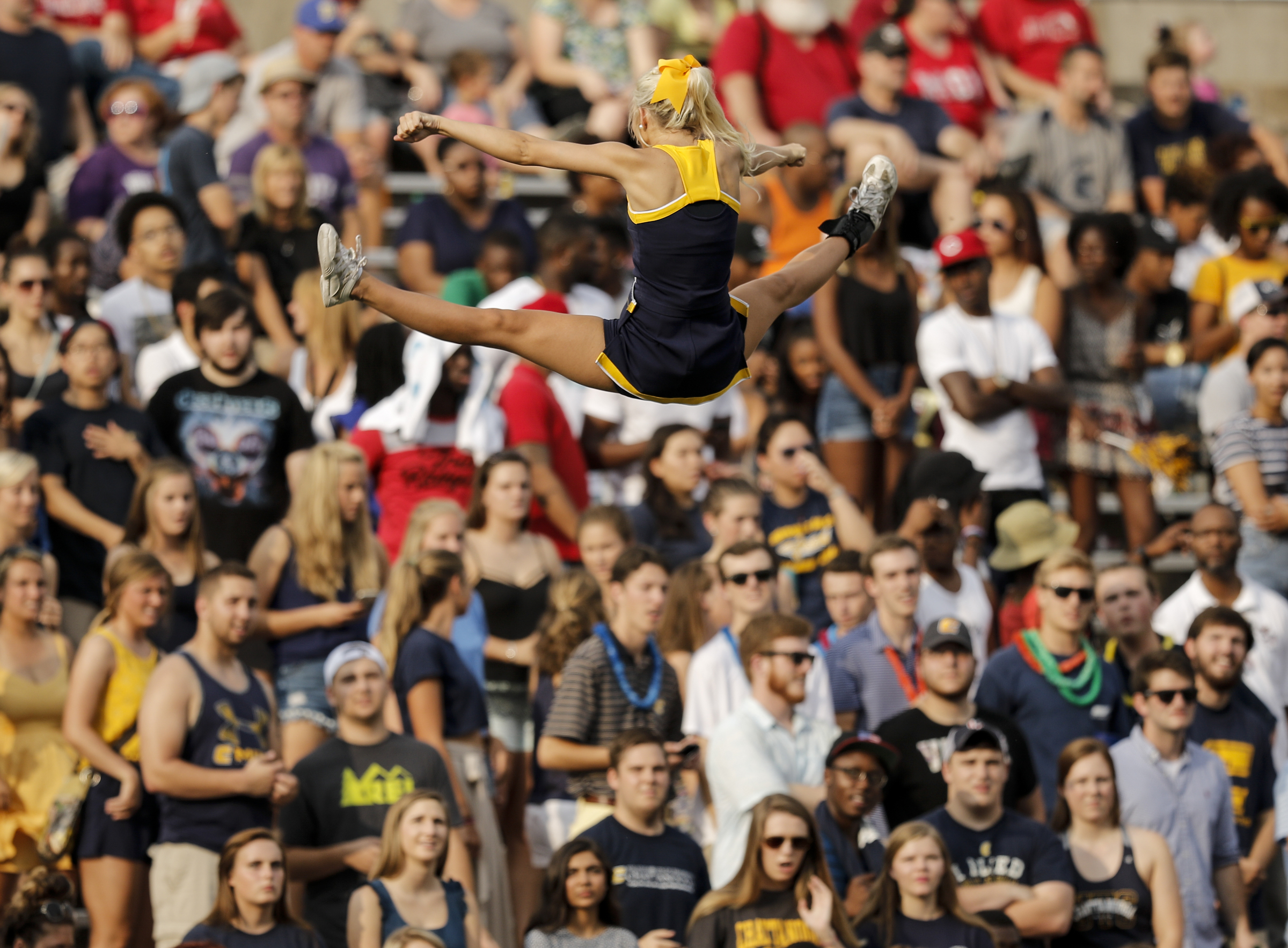 A UTC cheerleader is thrown into the air during the Mocs' season-opener football game against Jacksonville State at Finley Stadium on Saturday, Sept. 5, 2015, in Chattanooga, Tenn.