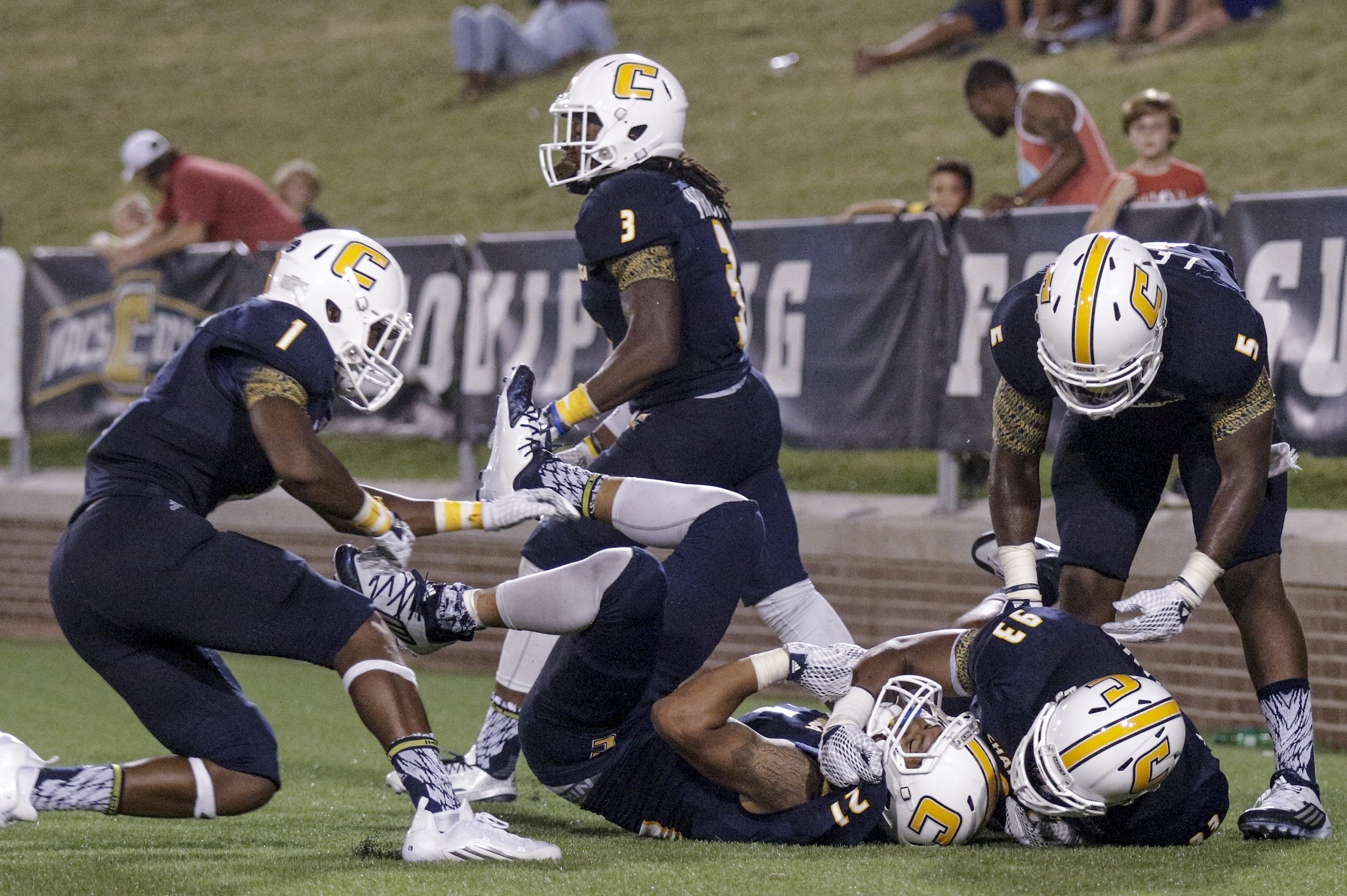 Teammates celebrate with Montrell Pardue (21) after Pardue stripped the ball and ran it for a touchdown during the Mocs' season-opener football game against Jacksonville State at Finley Stadium on Saturday, Sept. 5, 2015, in Chattanooga, Tenn.